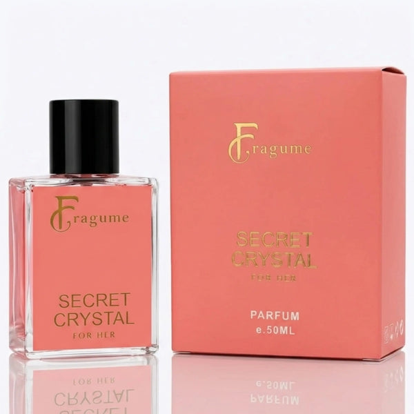 Fragume Secret Crystal For Her perfume bottle and its matching coral pink packaging box, both featuring gold lettering, set against a clean white background with a subtle reflection.